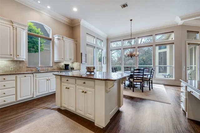 a open kitchen with granite countertop a sink a counter top space and stainless steel appliances