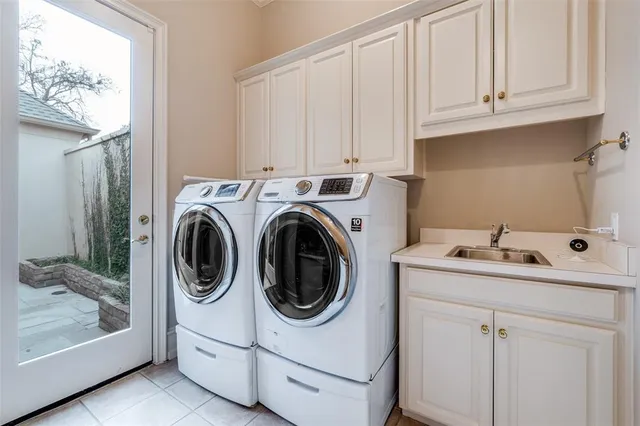 a utility room with sink dryer and washer