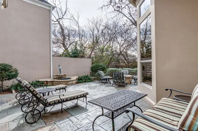 a view of backyard with seating area and trees