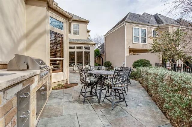 a view of a patio with table and chairs and potted plants