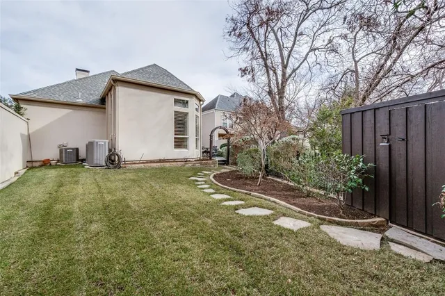 a backyard of a house with table and chairs