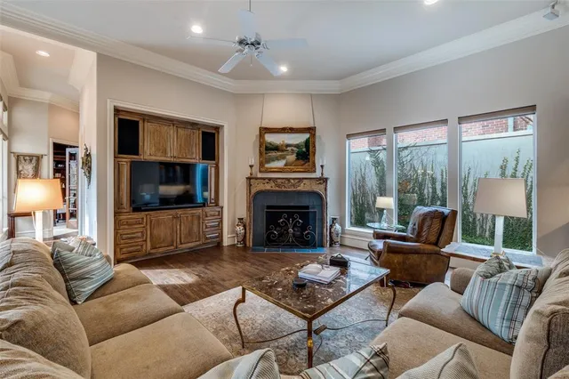 a living room with furniture a large window and a fireplace