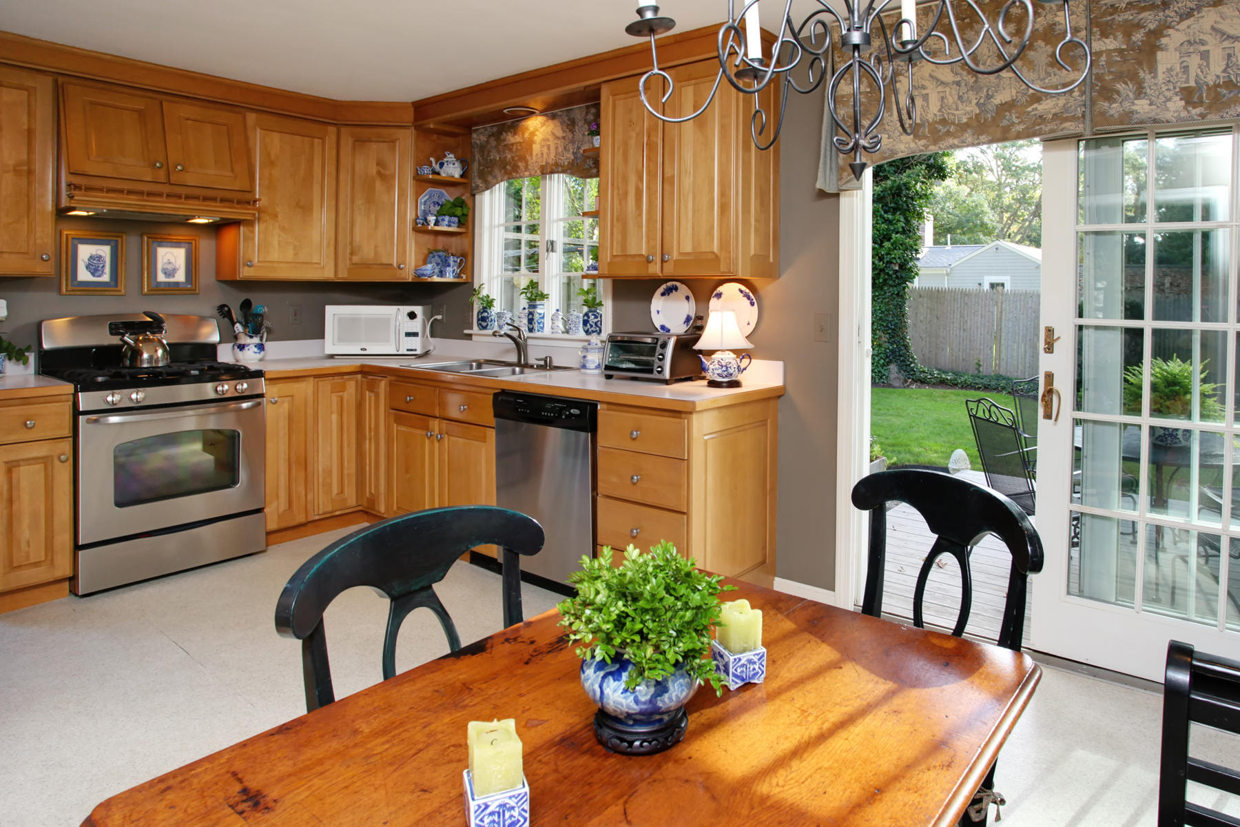 120 Fuller Road Centerville, MA 02632 - Photo 11 of 35 a kitchen with stainless steel appliances granite countertop a stove a sink and a dining table with garden view