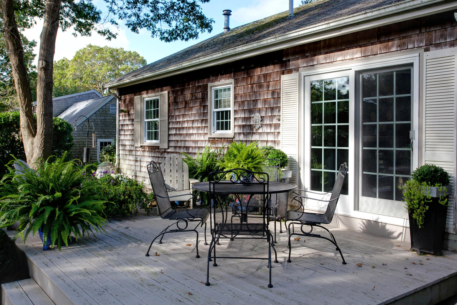 120 Fuller Road Centerville, MA 02632 - Photo 5 of 35 a patio with table and chairs and potted plants