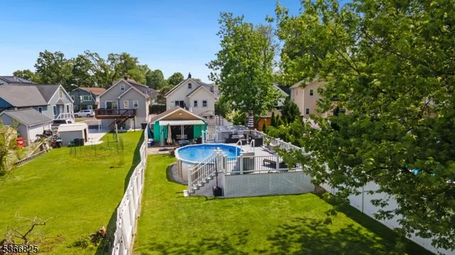 a aerial view of a house with swimming pool garden and patio