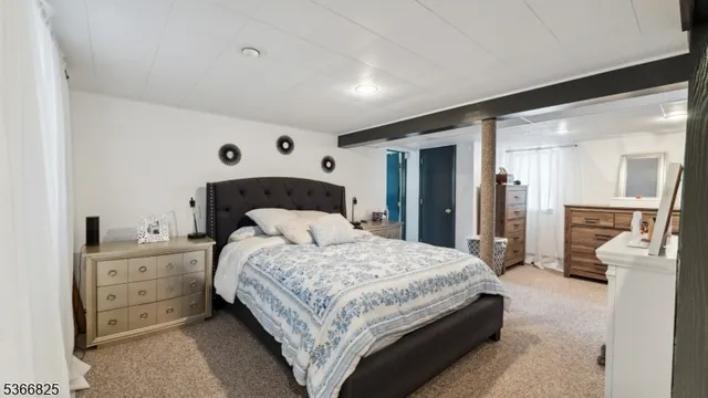 a bedroom with a bed and a large mirror