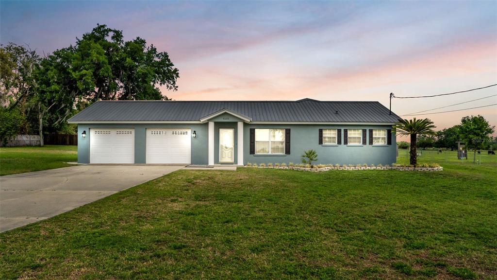 6110 Downing Street Dover, FL 33527 - Photo 1 of 1 a front view of a house with a garden