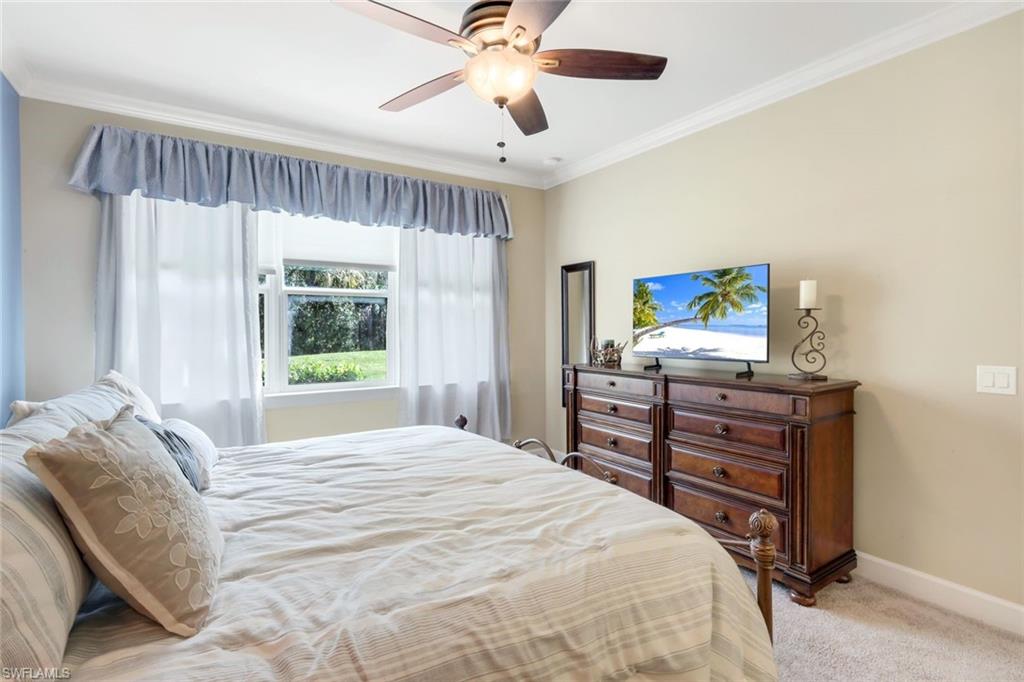 9532 Ironstone Terrace, Unit 102 Naples, FL 34120 - Photo 12 of 45 Bedroom with light carpet, crown molding, and a ceiling fan
