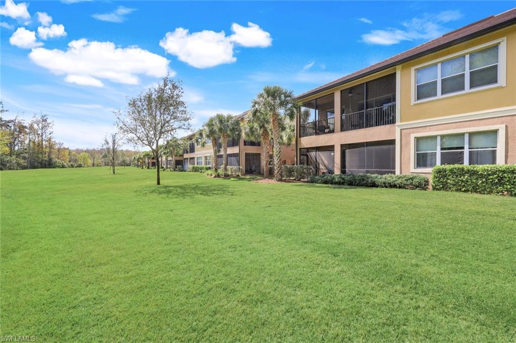 9532 Ironstone Terrace, Unit 102 Naples, FL 34120 - Photo 21 of 45 View of grassy yard featuring a sunroom