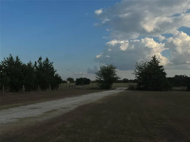 a view of pool with lawn chairs