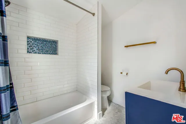 a bathroom with a shower and a sink