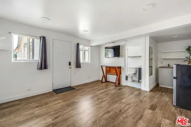 a view of a livingroom with wooden floor and a ceiling fan