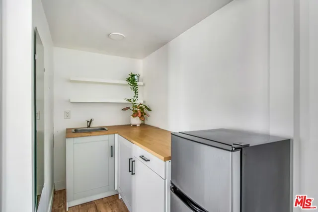 a kitchen with a sink and a refrigerator