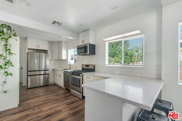 a kitchen with a stove a sink and a refrigerator