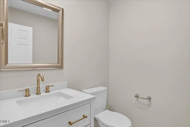 a bathroom with a sink a toilet and mirror