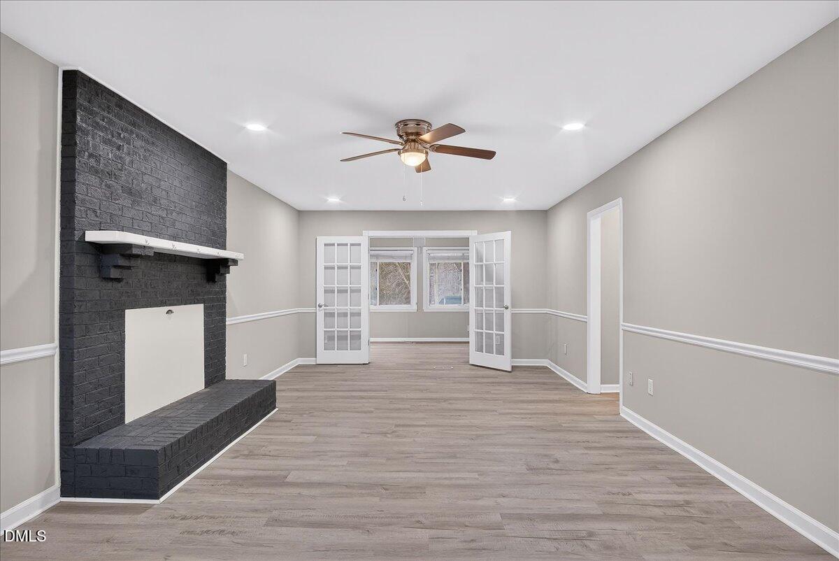 13013 Meadow Ridge Drive Rougemont, NC 27572 - Photo 3 of 27 a view of empty room with wooden floor and fan