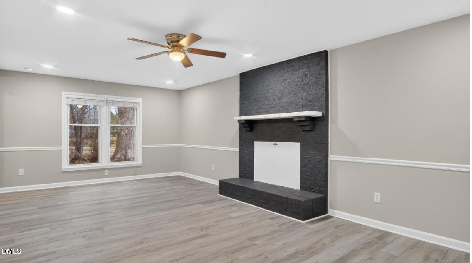 13013 Meadow Ridge Drive Rougemont, NC 27572 - Photo 4 of 27 a view of an empty room with wooden floor and a window