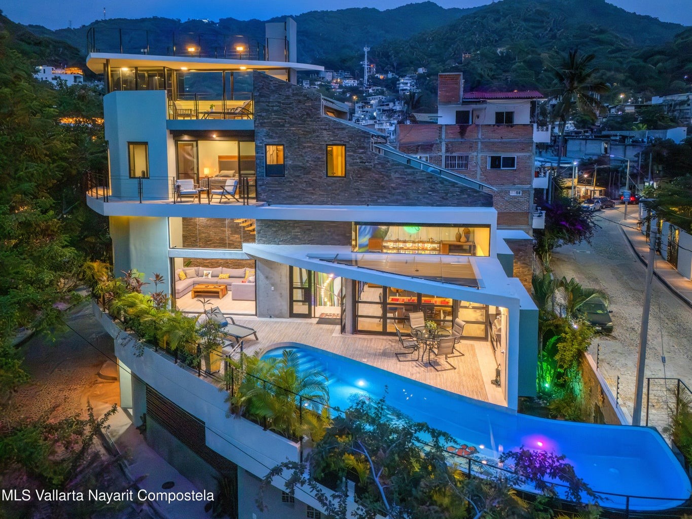 an aerial view of a house with a yard swimming pool outdoor seating