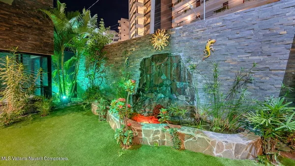 a backyard with table and chairs and potted plants