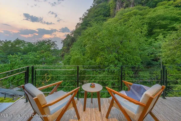 a view of a chair and tables on the roof deck