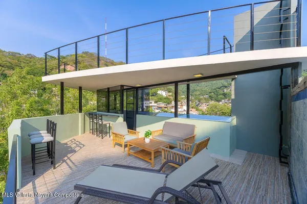 a view of a patio with a table chairs and a table