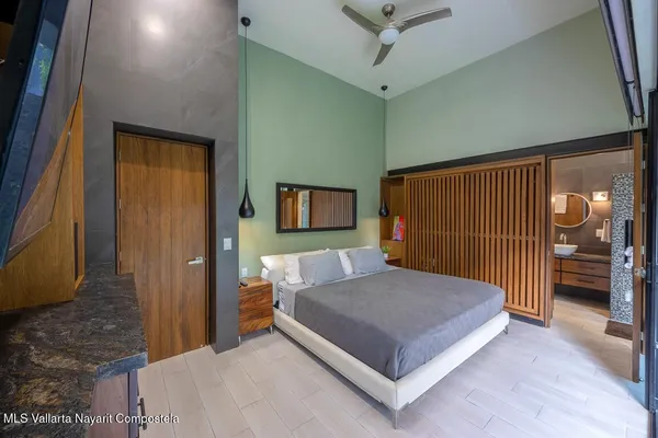 a bedroom with a bed and a large window
