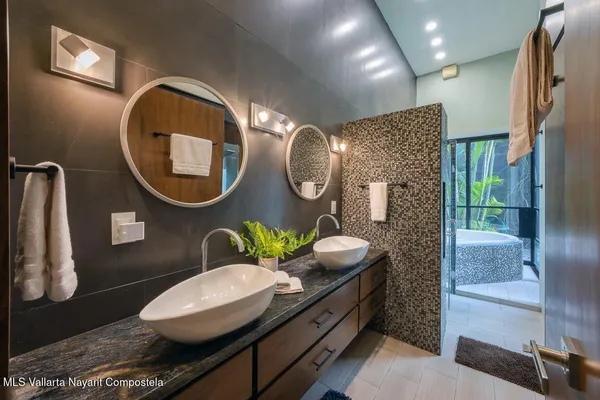 a bathroom with a toilet mirror and vanity