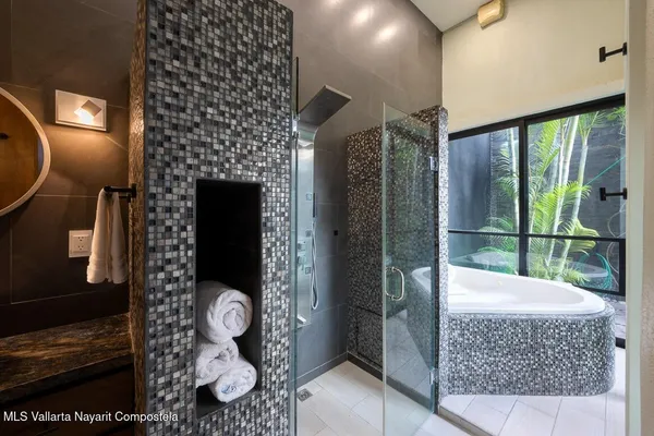 a bath room with a fireplace and a shower