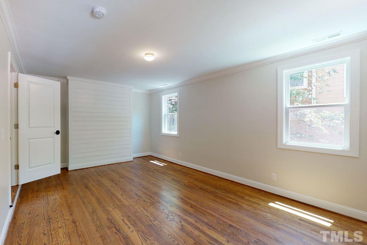 1304 Dixie Trail Raleigh, NC 27607 - Photo 11 of 26 a view of an empty room with wooden floor and a window