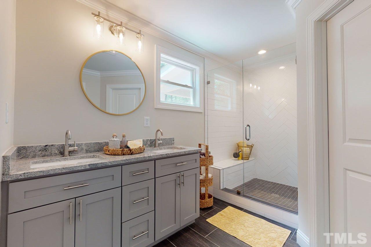 1304 Dixie Trail Raleigh, NC 27607 - Photo 13 of 26 a en suite bathroom with a granite countertop sink a mirror and a