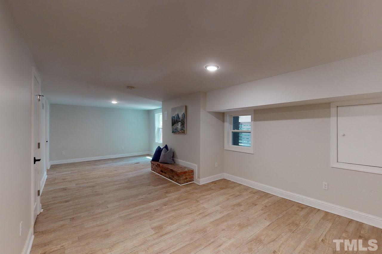 1304 Dixie Trail Raleigh, NC 27607 - Photo 20 of 26 an empty room with wooden floor and windows