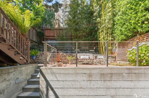 a backyard of a house with table and chairs