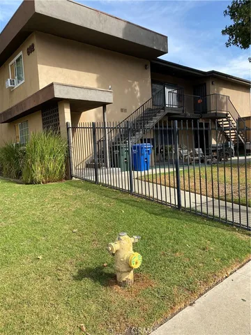 a view of a house with a yard and fence
