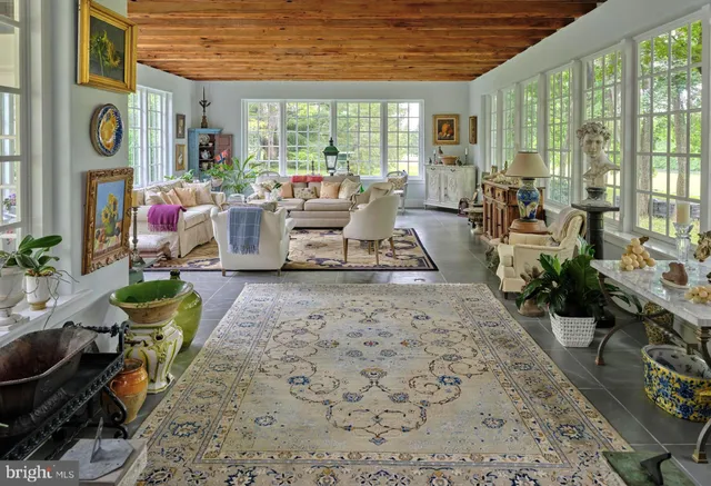 a view of room with furniture book shelf and wooden floor