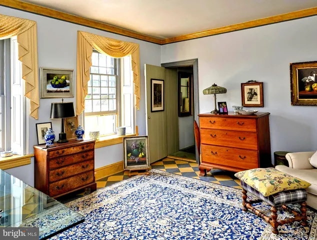 a spacious bedroom with a bed and wooden floor