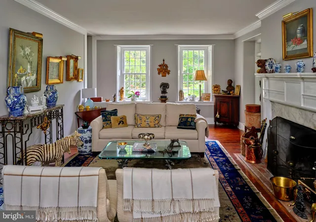 a front view of a house with a yard and potted plants
