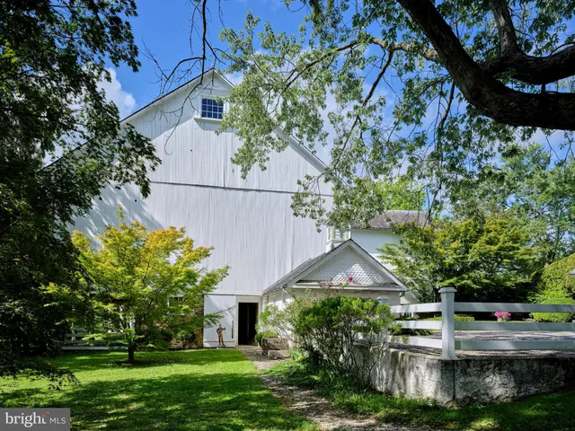 a front view of a house with a yard and fountain