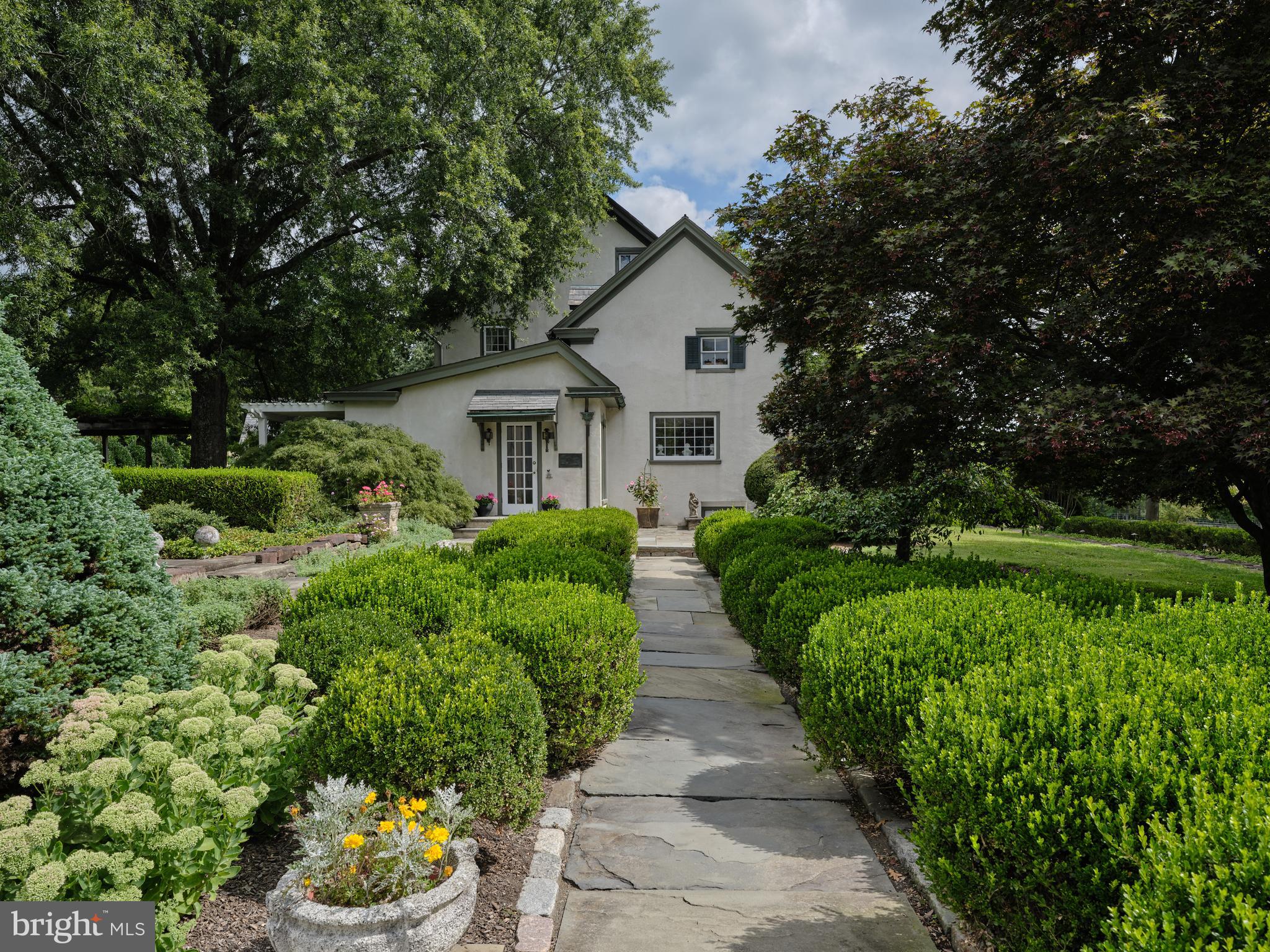 5382 Wismer Road Pipersville, PA 18947 - Photo 36 of 67 a front view of a house with a yard and potted plants