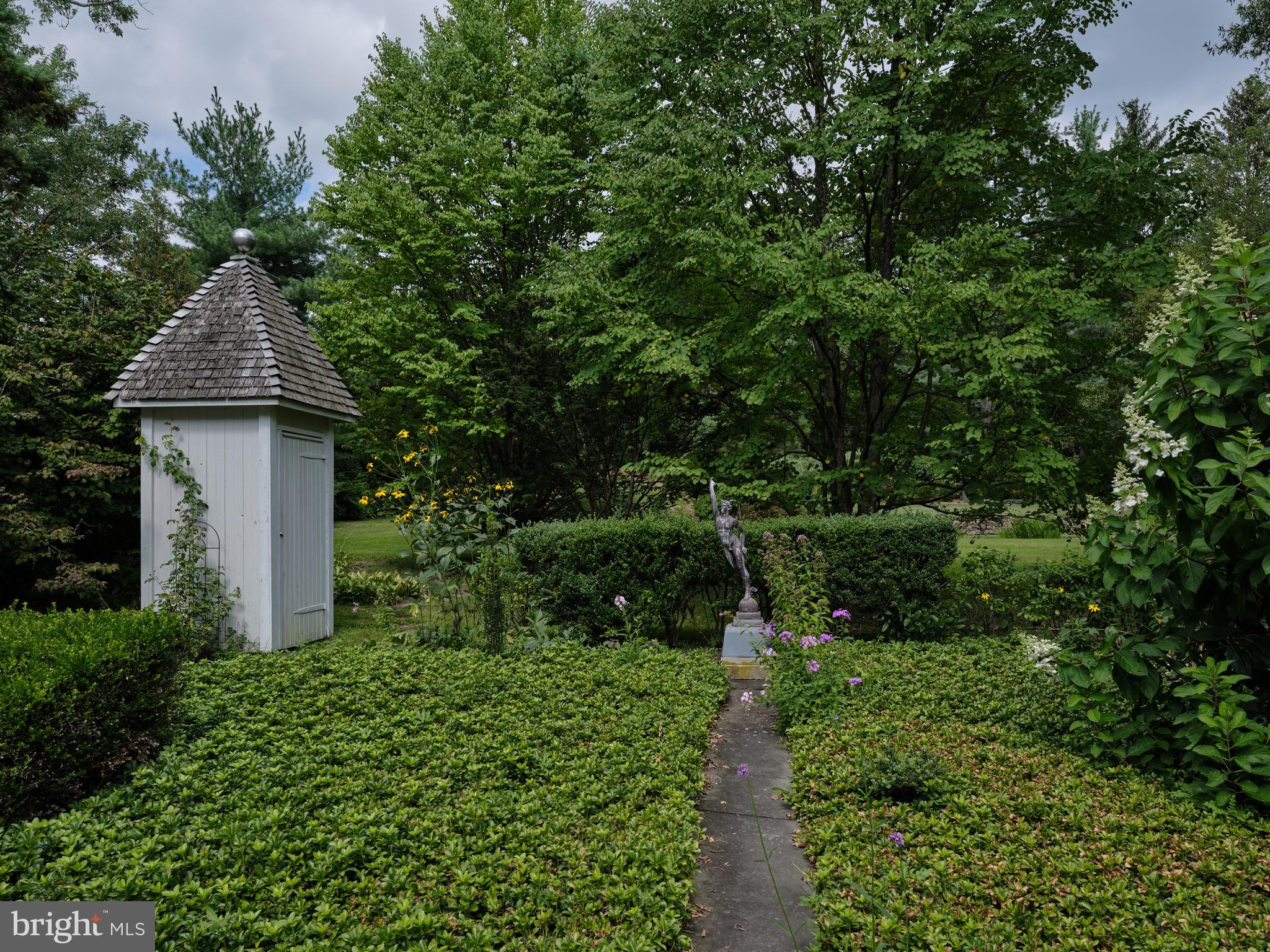 5382 Wismer Road Pipersville, PA 18947 - Photo 42 of 67 a front view of a house with a yard and fountain