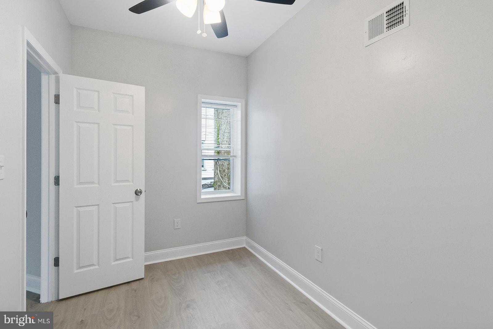 5213 Rodman Street Philadelphia, PA 19143 - Photo 22 of 31 an empty room with windows and chandelier fan