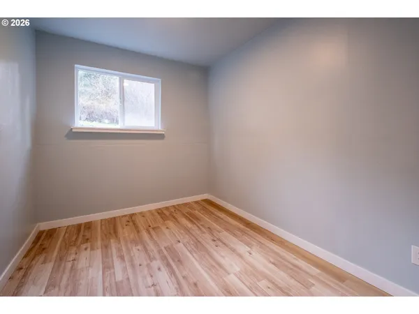 a view of an empty room and wooden floor