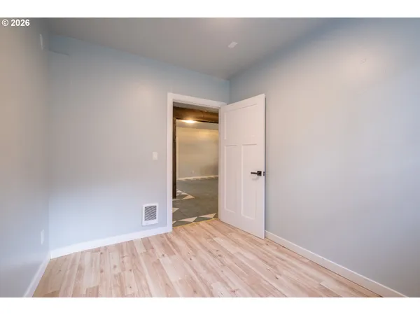 a kitchen with a sink cabinets and wooden floor