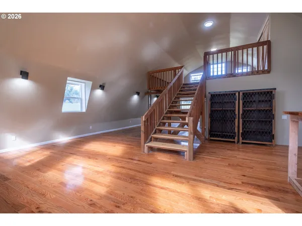 a view of a livingroom with furniture staircase and a kitchen