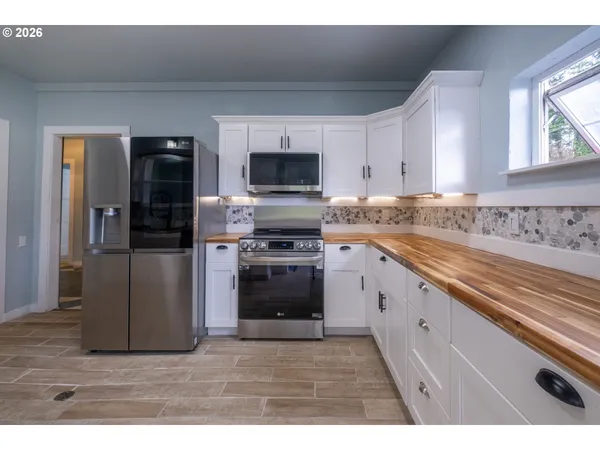 a kitchen with a stove a sink and a refrigerator