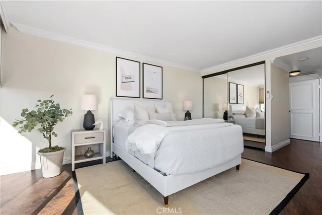 a bedroom with a bed and a potted plant