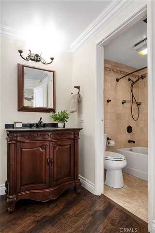 a bathroom with a granite countertop sink toilet a mirror and shower