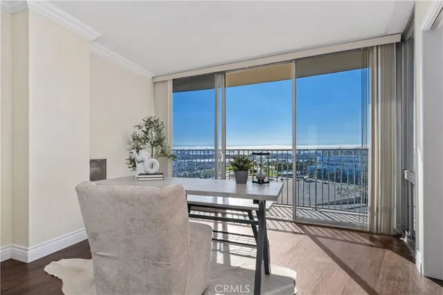 a dining room with furniture and a floor to ceiling window