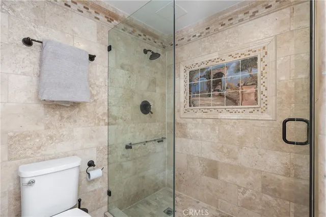 a bathroom with a shower and a toilet