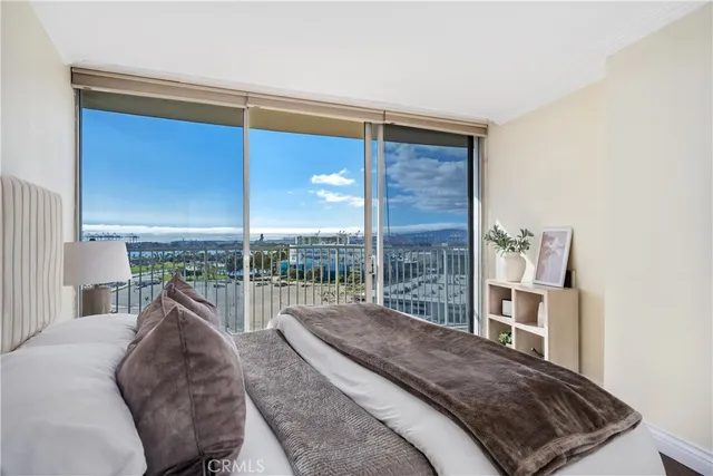 a bedroom with a bed and a large window