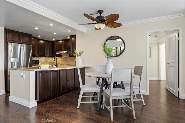 a kitchen with a dining table cabinets and stainless steel appliances